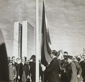 Foto de Juscelino Kubitschek hasteando a bandeira na inauguração de Brasília.